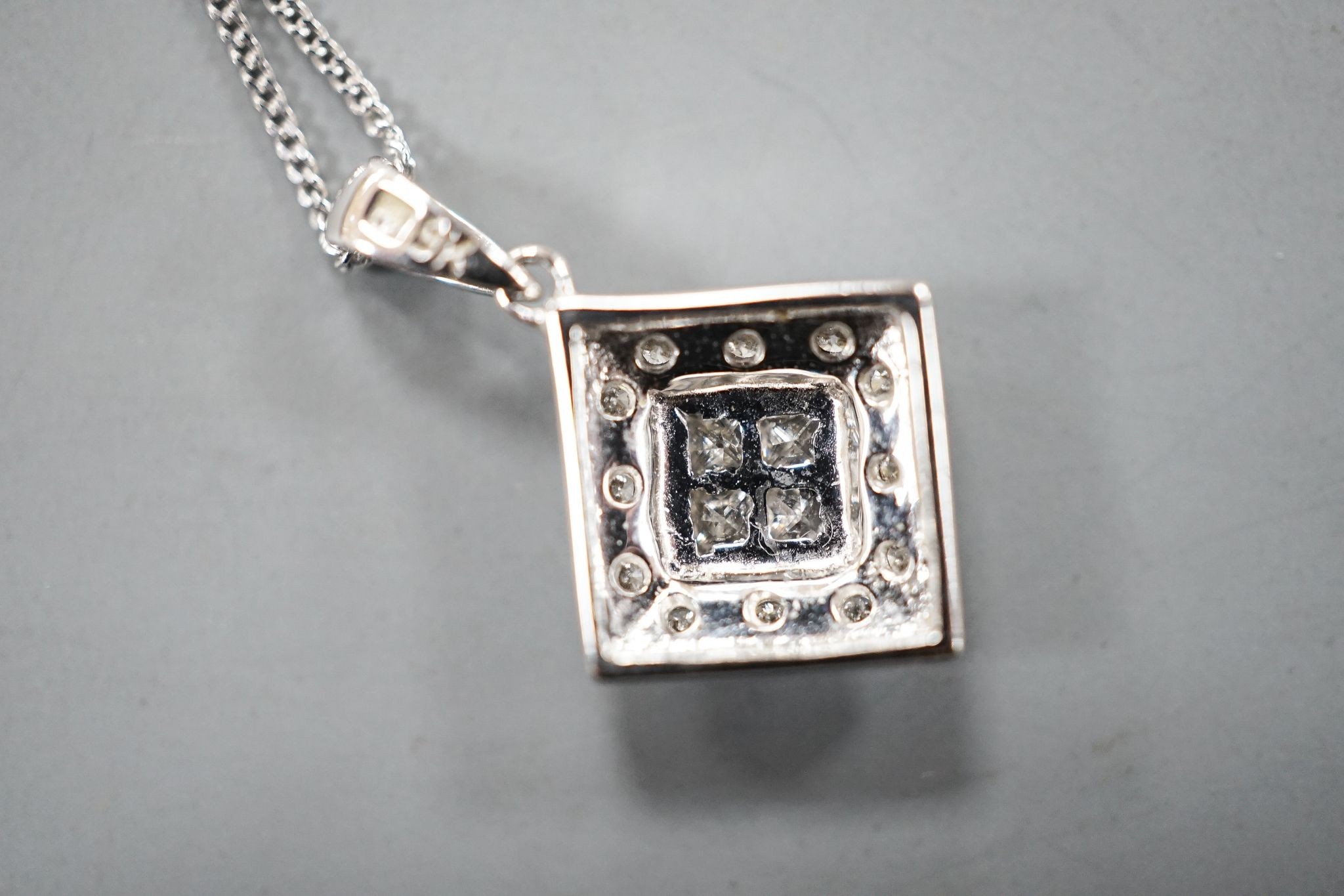 A modern 9k and diamond chip set pendant, 10mm, on a 585 fine link chain, 44cm, gross weight 2.1 grams.